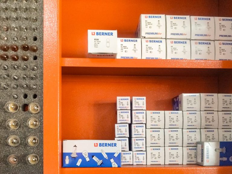 Taller neumáticos Buenas Ruedas Murcia equipamiento profesional Servicio montaje ruedas equilibrado Murcia Estantes con cajas de bombillas para vehículos organizadas en diferentes tamaños.